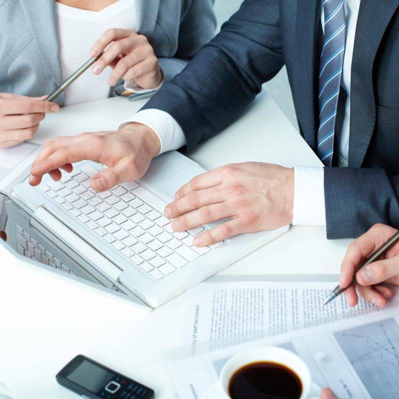 Group of business people working with laptop at meeting